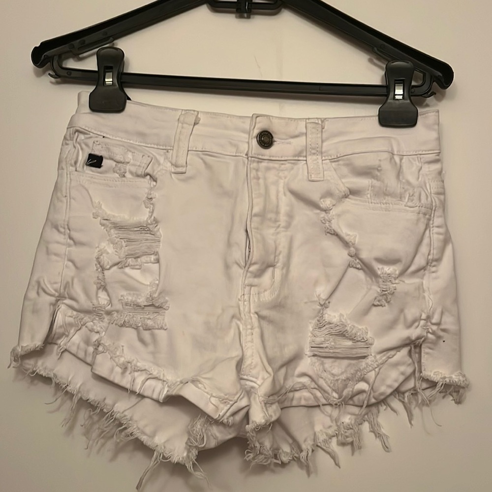 White jean shorts with holes, lightly worn